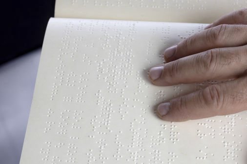 A hand reading braille